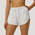 white Front view of women’s high-waisted elastic running shorts featuring a supportive tummy control waistband - BetterPlace