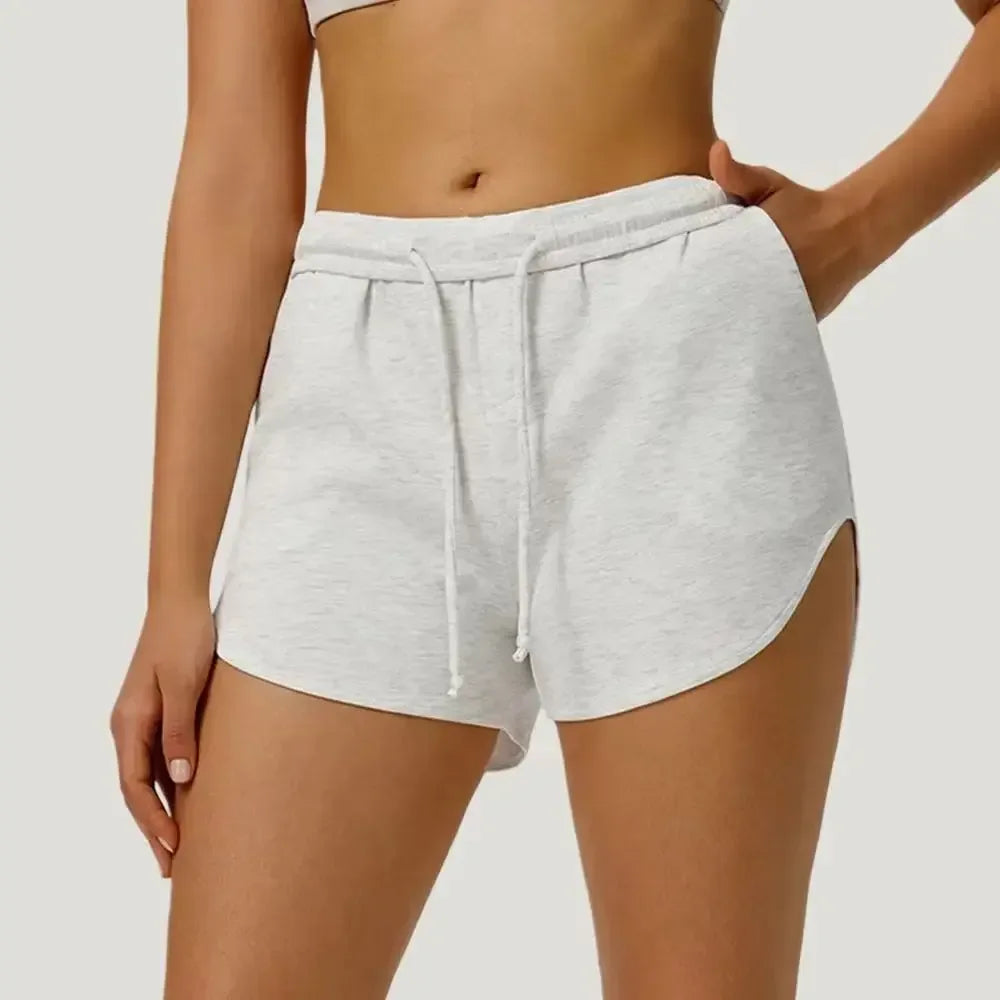 white Front view of women’s high-waisted elastic running shorts featuring a supportive tummy control waistband - BetterPlace
