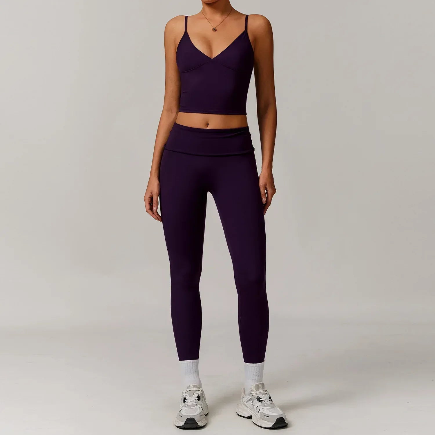 Woman wearing a seamless v-neck tank top and high waisted tight leggings with tummy control for a slimming workout or yoga outfit - BetterPlace