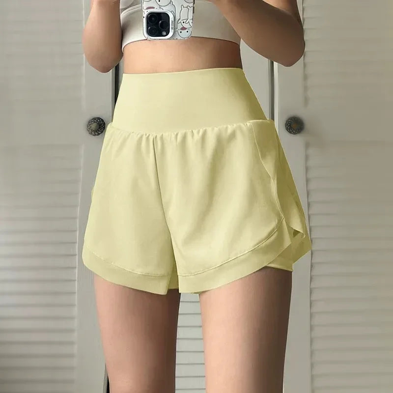yellow front view of women’s 2-in-1 running shorts showing the breathable outer layer and high-waisted fit. - BetterPlace