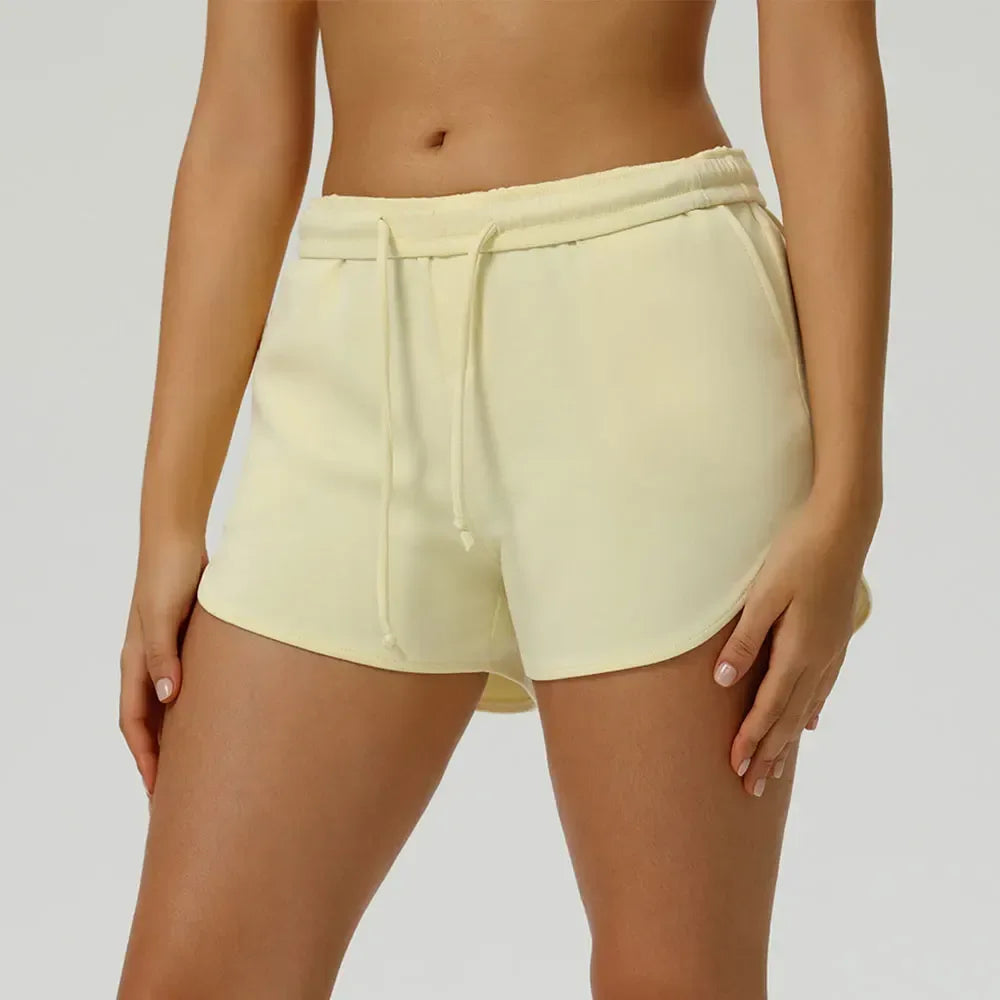 yellow Front view of women’s high-waisted elastic running shorts featuring a supportive tummy control waistband - BetterPlace