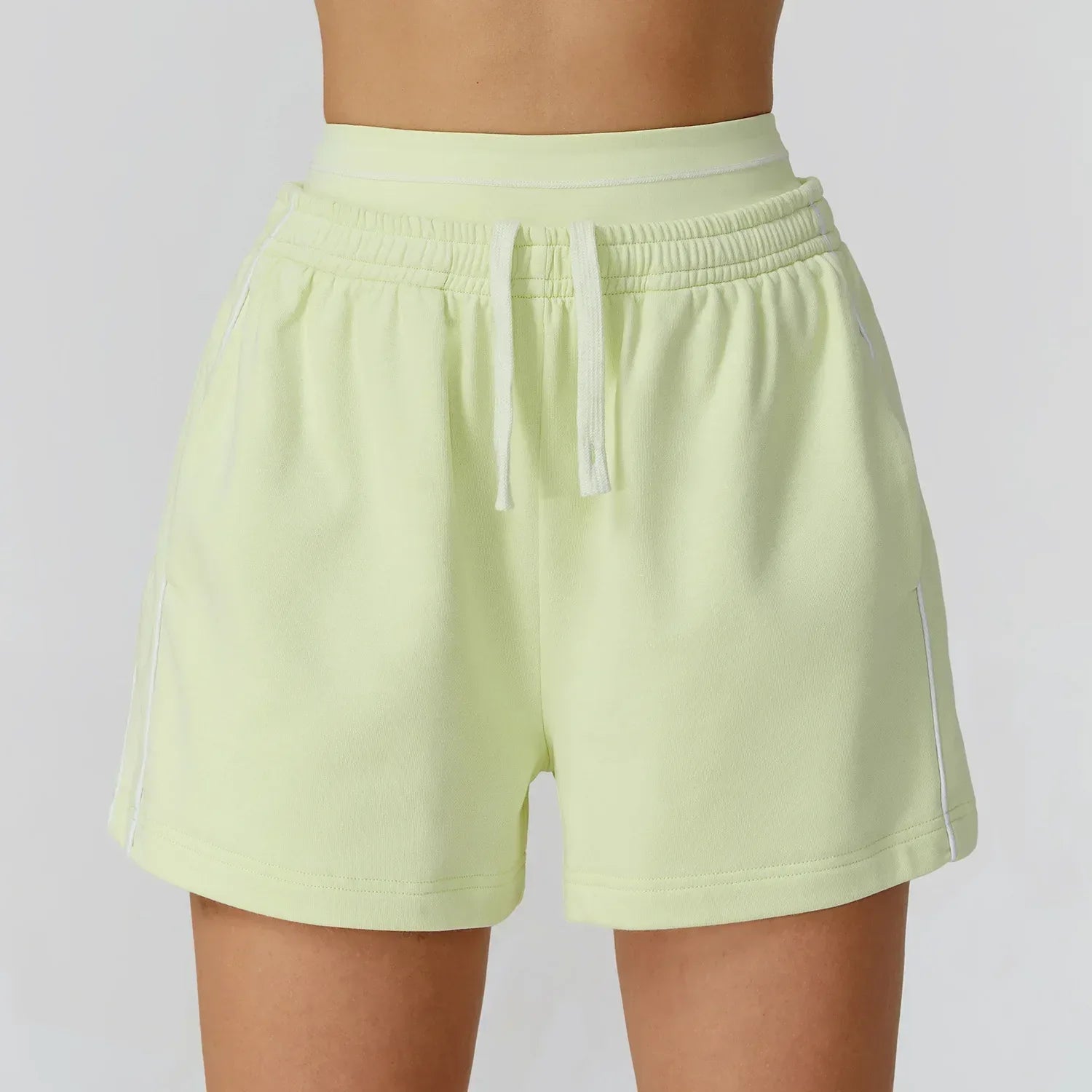 yellow Front view of women’s high-waisted loose pocket shorts in a breathable athletic fabric - BetterPlace